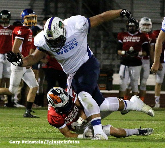 Lemoore's Noah Wright tackles Farmersville's Jeremiah Galavis for a loss om the third quarter of Saturday night's East West All Star Game in Visalia.